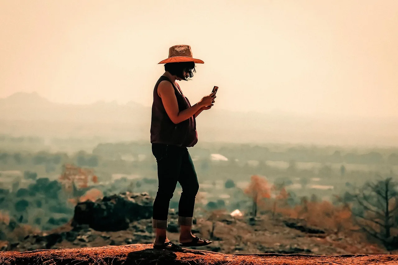 woman, female, sunrise, nature, sun, asian, walking, alone, walk, fog, sky, hill, landscape, land, desert, dune, barren, arid, mountain, hat, cellphone, smartphone, windy