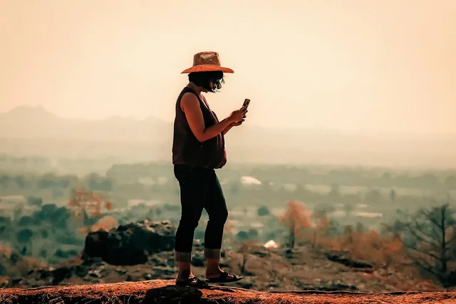 woman, female, sunrise, nature, sun, asian, walking, alone, walk, fog, sky, hill, landscape, land, desert, dune, barren, arid, mountain, hat, cellphone, smartphone, windy. Travel creators: a market-entry checklist for tourism teams