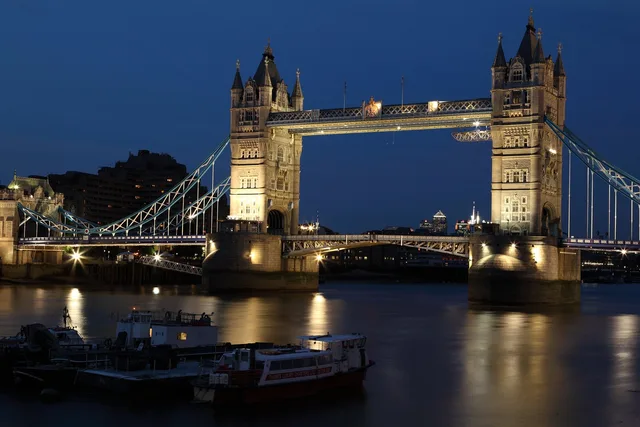 bridge, london, architecture, london bridge, illuminated, infrastructure, river, thames, river thames, boats, vessels, landmark, famous, tourist attraction, nature, tourist destination, building, england, lights, night, towers, water. Estimate travel influencer campaign spend in England before quoting
