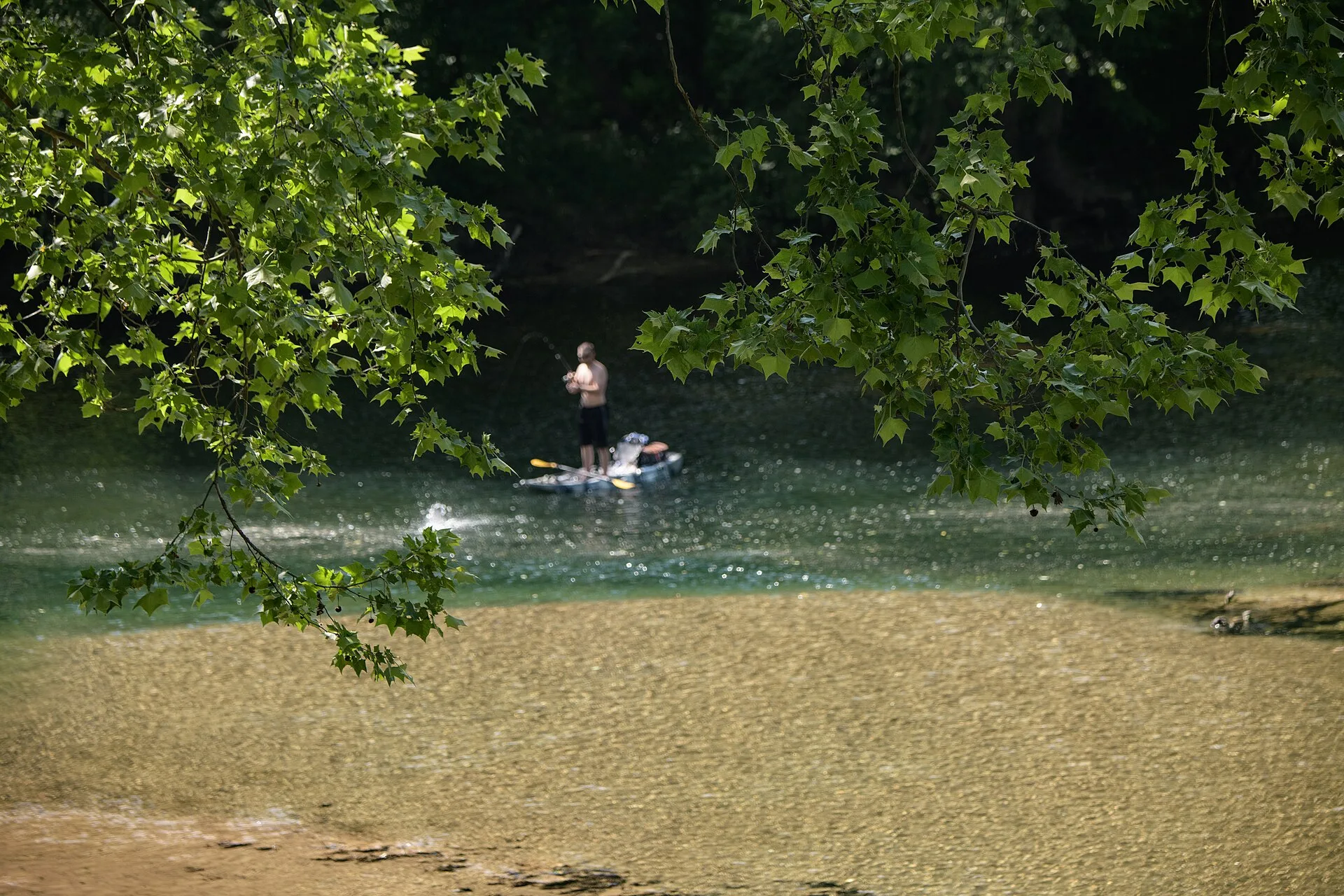 A fisherman with a standup paddleboard on the Elk River, in West Virginia, on May 25, 2023. The 73-mile Elk River trail winds through Braxton and Clay County, and the 102-mile Elk River Water Trail flows from Sutton to Charleston, WV. These trails are included in the Pioneer Trail Network that conne