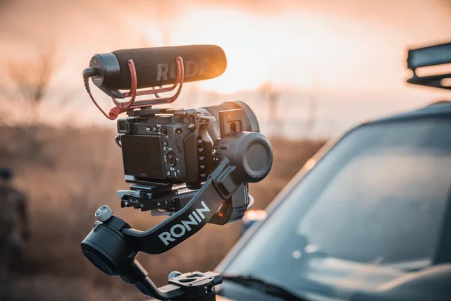 gimbal stabilizer, photography equipment, filming equipment, dawn, outdoors, camera, vlogging equipment, camera, camera, camera, camera, camera. Travel creator day rates compared across London, Cardiff and Edinburgh